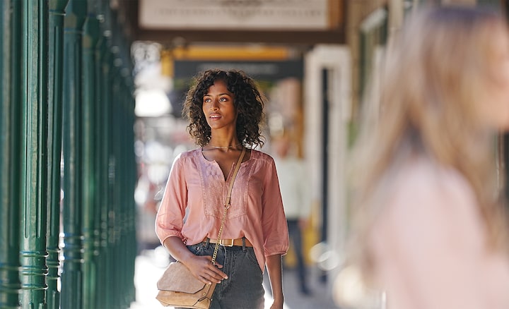 Photo of a woman walking in the street