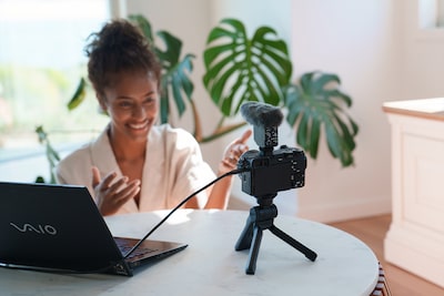 Photo of a woman live streaming with the camera