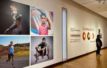 Gallery Installation showing three athletics and a young boy with prosthetics