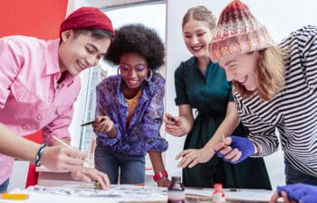 Diverse group of High School students work together on a design project.