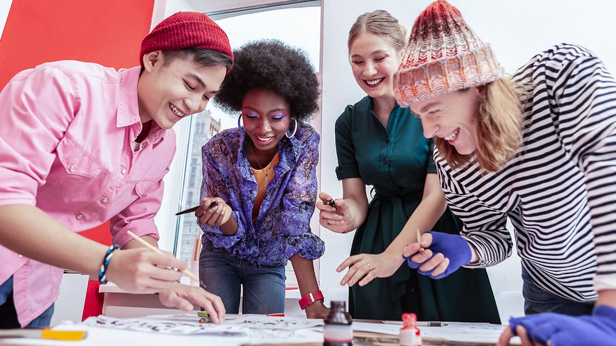 Diverse group of High School students work together on a design project.