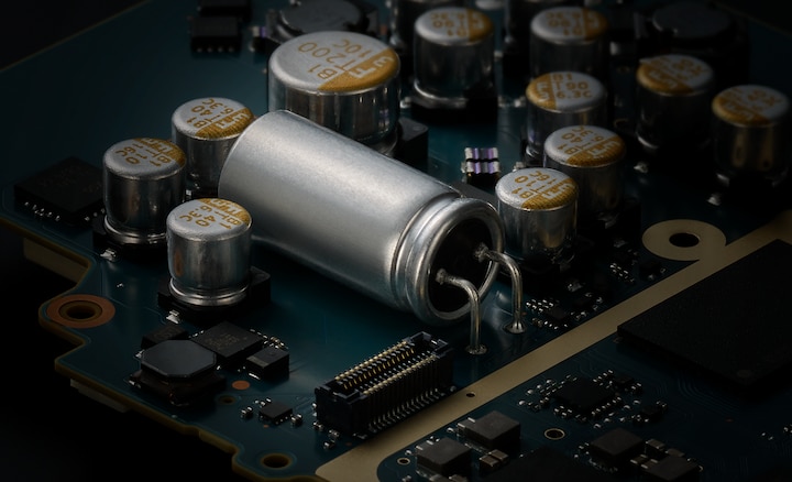 Close-up of circuit board with large solid high polymer capacitor