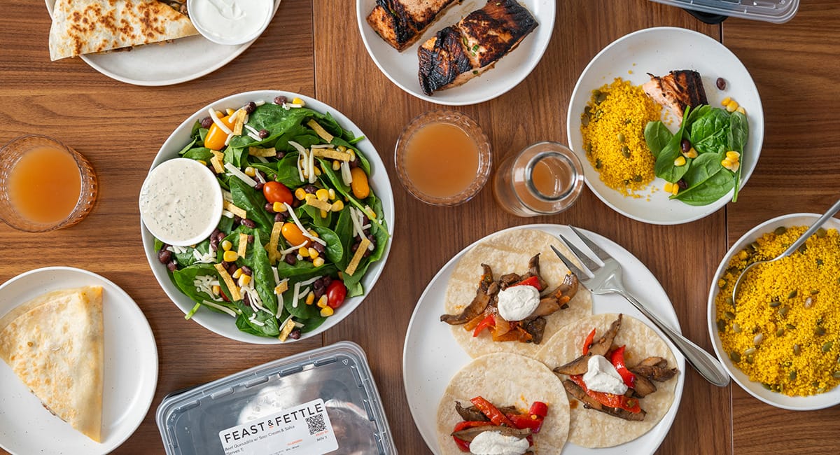 Feast & Fettle meal delivery contents. An array of plated meals displayed on a table.