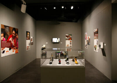 Exhibition installation with display of prosthetic feet in the center of the room.