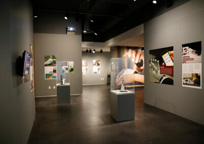 Exhibition installation showing various artifacts on display including the Complete Control System.