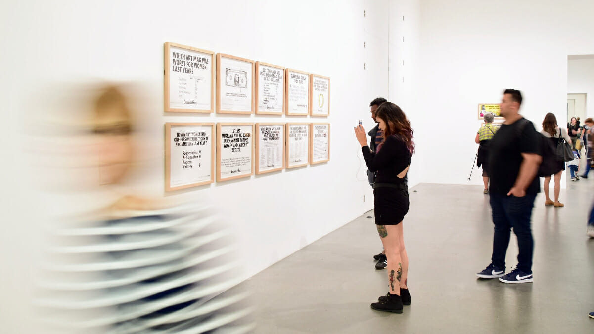 People looking at drawings in a gallery space