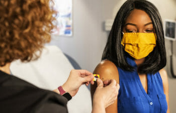 Person with mask getting vaccinated