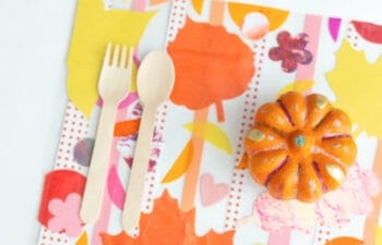 Colorful placemat with a small painted pumpkin and utensils