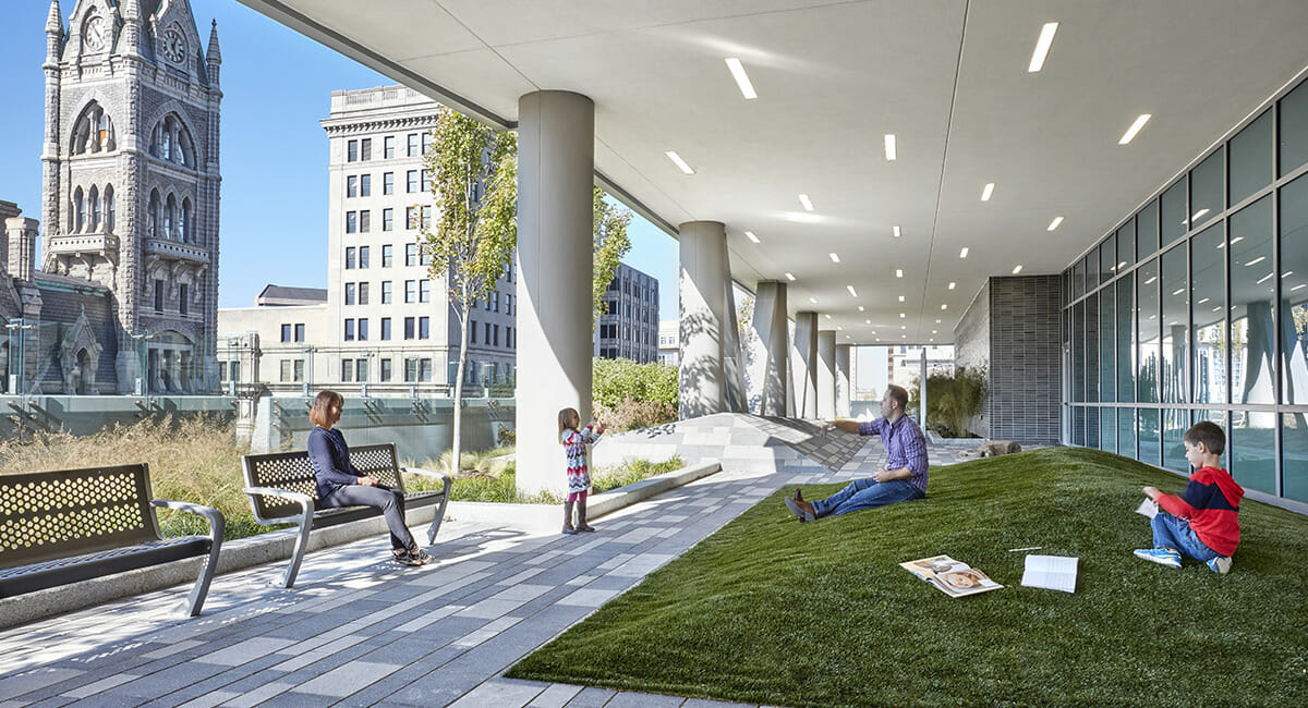 Photo of family playing in an outdoor city environment